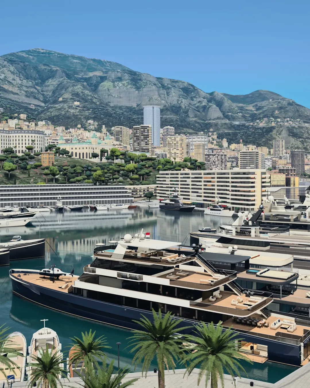 HALCYON VI from above the quay in Port Hercule: her navy hull with the helicopter on the bow, Monte-Carlo, the Casino gardens and the mountain behind her, palms along the quay.